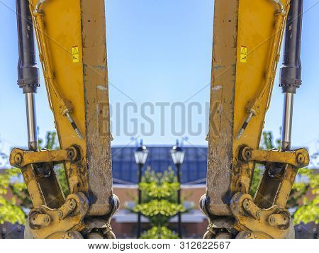 Dual Views Of A Yellow Tractor Arm Vertical