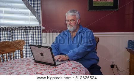 Senior Happy Using A Computer And Technology