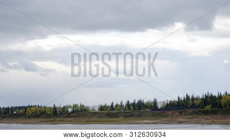 The Viluy River Flows Past The Shore With The Village Of North Ulus Suntar On The Shore With Storage