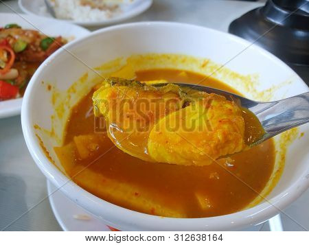 Thai Food Style,selective Focus Of Snapper Fish On Blurred Sour Soup And Young Coconut Shoots In Whi