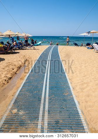 Malia, Crete, Greece - Juni 18, 2019: People Are Resting On A Sunny Day At The Beach In Malia, Crete