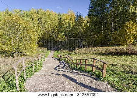 A Foot Path Crosses A Small Ravine. Landscape Reserve Teply Stan, Moscow, Russia. Sunny Day In Octob