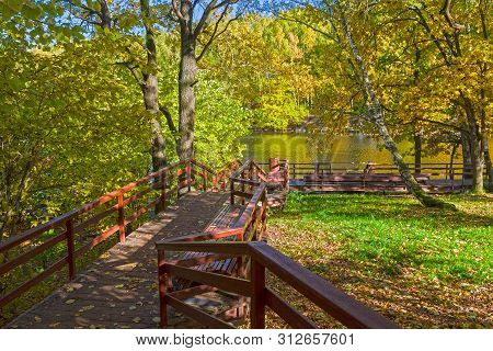 Well-maintained Pedestrian Walkway To The Shore Of The Pond. Sunny Day In October. Landscape Reserve
