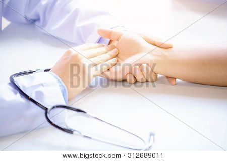 Close Up Of Doctor Measuring Patient Heart Beat, Medicine And Health Care Concept
