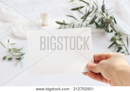 Feminine Wedding, Birthday Greeting Card Mockup Scene With Womans Hand Holding Blank Paper Card. Blu