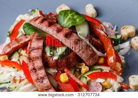 Salad With Grilled Sausage Paprica Cucumber And Croutons