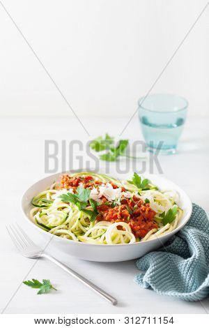 keto paleo zoodles bolognese: zucchini noodles with meat sauce and parmesan