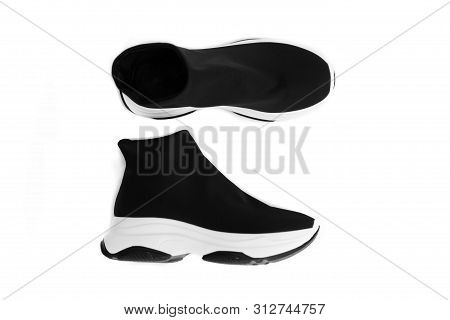 Pair Of Black And White Knitted Sneakers. Popular Trendy Shoes. Top View, Isolated