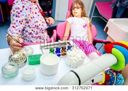 Set Of Dentist Tools And Equipment On Clinic Desktop