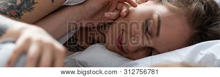 Panoramic Shot Of Two Lesbians Touching Each Other While Lying In Bed