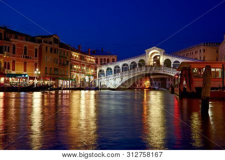 Night Shot Of Rialto Bridge ( Ponte Rialto ) On Canal Grande In Venice, Veneto, Italy