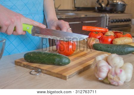 Chef Cuts The Vegetables Into A Meal. A Woman Uses A Knife And Cooks. Woman's Hands Cutting Vegetabl