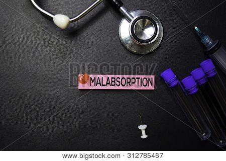 Malabsorption Text On Sticky Notes. Top View Isolated On Black Background. Healthcare/medical Concep