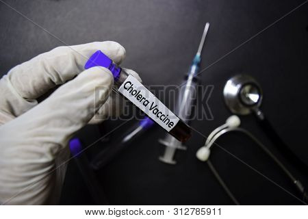 Cholera Vacine Text With Blood Sample. Top View Isolated On Black Background. Healthcare/medical Con
