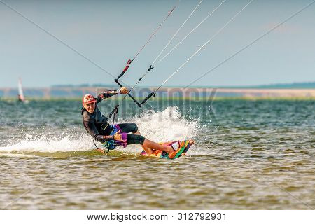 Anapa, Russia - July 9, 2017: Man Kitesurfer Rides Kite Splashing On Bugaz Firth At Black Sea Coast 