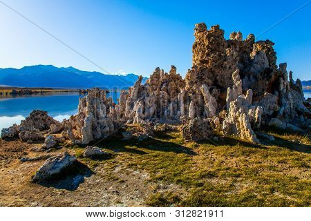 Picturesque lake with lime-tuff towers Tufa - of fancy shape. California, USA. Mono Lake. Evening by the lake. Dusk. The concept of ecological, exotic and photo tourism