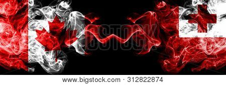 Canada Vs Tonga, Tongan Smoky Mystic Flags Placed Side By Side. Thick Colored Silky Smoke Flags Of C