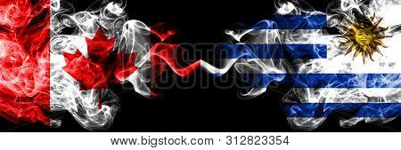 Canada Vs Uruguay, Uruguayan Smoky Mystic Flags Placed Side By Side. Thick Colored Silky Smoke Flags