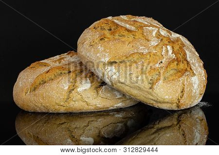 Group Of Two Whole Fresh Baked Rye Wheat Bread Isolated On Black Glass