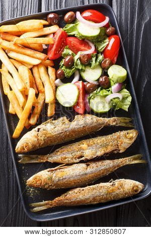 Fried Mediterranean Boops Boops Fish Served With Fresh Salad And French Fries Close-up On A Plate. V