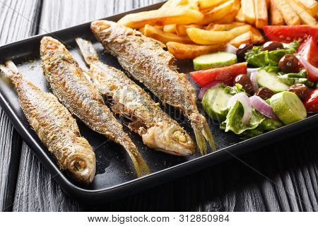 Mediterranean Cuisine Fried Boops Boops Fish With Fresh Vegetable Salad And French Fries Close-up On