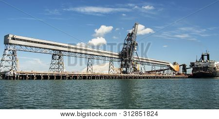 Port Of Gladstone. Waterfront Maritime Commercial Coal Loading Marina/dock Panorama With A Moored Sh