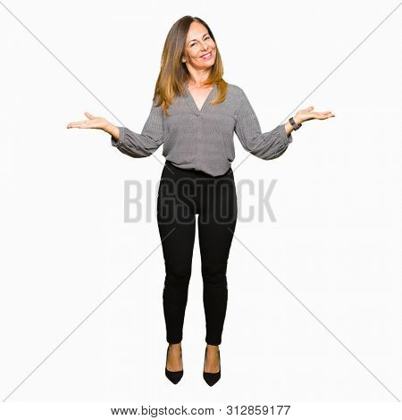 Beautiful middle age business woman Smiling showing both hands open palms, presenting and advertising comparison and balance