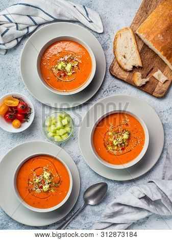 Gaspacho Soup On White Marble Tabletop. Three Bowls Of Traditional Spanish Cold Soup Puree Gaspacho 