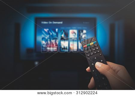 Vod Service Screen With Remote Control In Hand