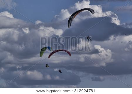 Izium, Ukraine - July 11, 2019: Paragliders On A Background Of Clouds In The Area Of ​​mount Kremene