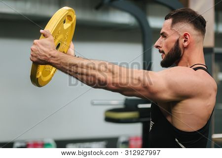 Bearden Bodybuilder In The Gym. Strong Man In Black T-shirt