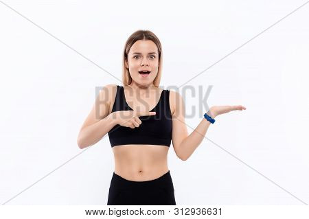 Young Sporty Blond Woman In A Black Sportswear With Smart Watches For Pulse Measuring Pointing With 
