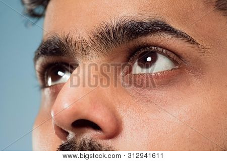 Close Up Portrait Of Young Hindoo Mans Face With Brown Eyes Looking Up Or At Side. Human Emotions, F