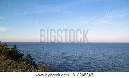 Baltic Sea From Cliff In Mechelinki, Poland. Nature And Travel Concept. Copy Space On Blue Sky.