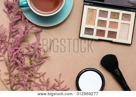 Make Up Concept Flat Lay Background. Make Up Brushes And Cosmetics, Cup Of Tea And A Blooming Tamari