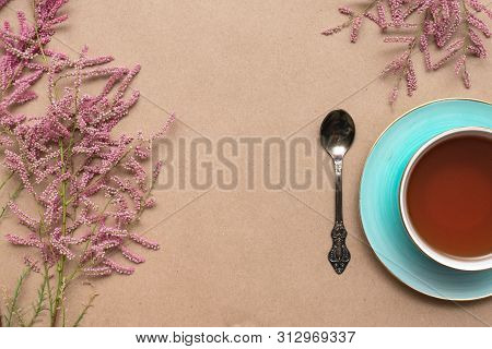 Cup Of Hot Tea And A Tamarix Gallica Tree Branches On A Brown Background.