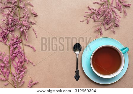Cup Of Hot Tea And A Tamarix Gallica Tree Branches On A Brown Background.