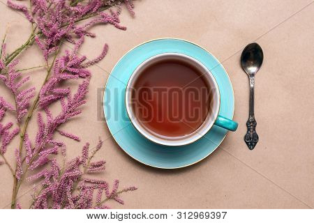 Cup Of Hot Tea And A Tamarix Gallica Tree Branches On A Brown Background.