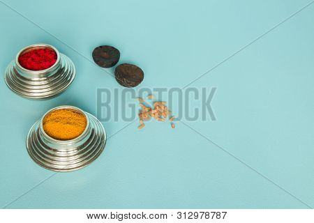 Sindoor Or Kumkum Silver Box, Areca And Rice On Blue Background Used In Hindu Religion.