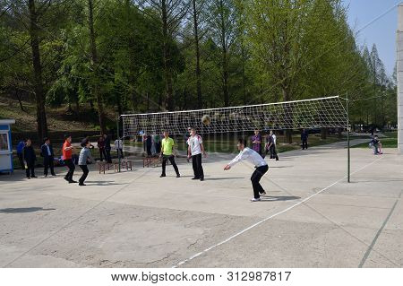 Pyongyang, North Korea - May 1, 2019: Amateurs Play Volleyball In A Public Park. Is An Amusement Par