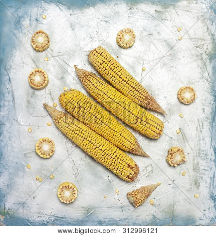 Shucked And Cleaned Sweet Corn On Bright Blue Background. Sweet Corn Cut On Desk.