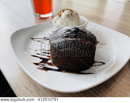 Dessert Fondan Chocolate With Ice-cream On A White Plate. Exquisite French Chocolate Dessert Top Vie