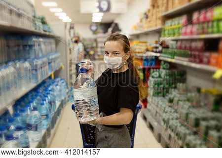 Buyer Wearing A Protective Mask.shopping During The Pandemic.emergency To Buy List.water Supplies Sh