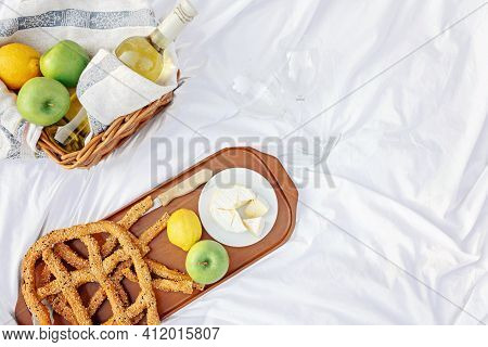 Breakfast At Sunrise, On The Grass White Sheet With A Tray With Cheese And Vine, Dry Bread, Apple, L