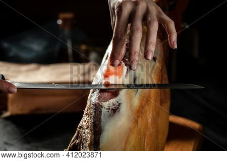 Dry Spanish Ham, Iberian Ham Cutter On Black Background. Iberian Ham Cutter. Traditional Spanish Ham
