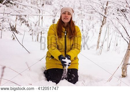 Beautiful Sexy Girl Tosing Snow. Around The Trees In The Snow
