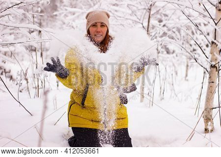 Beautiful Sexy Girl Tosing Snow. Around The Trees In The Snow