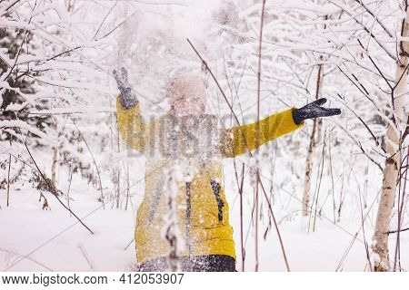 Beautiful Sexy Girl Tosing Snow. Around The Trees In The Snow