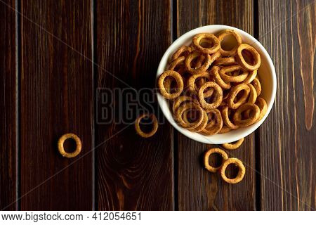 Small Wheat Bagels In White Ceramic Bowl On Dark Rustic Table, Top View, Copy Space