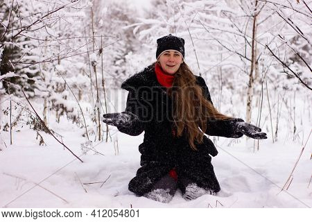 Beautiful Sexy Girl Tosing Snow. Around The Trees In The Snow